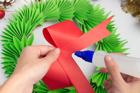 Christmas wreath made of colored paper. DIY concept. Handmade at home. step by step instructions. step 23.の写真素材
