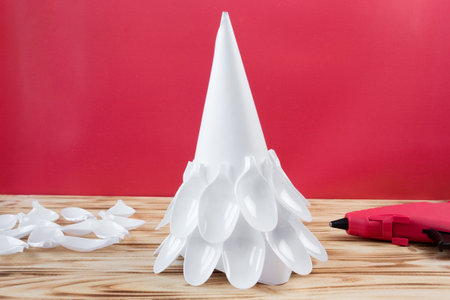 Christmas tree made of disposable spoons. step by step instruction. Handmade, DIY. Plastic recycling concept.の写真素材
