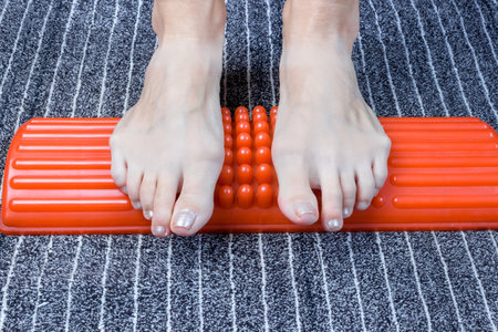 Massage of wooman feet with an acupuncture massager. Acupressure. alternative medicine concept.の写真素材
