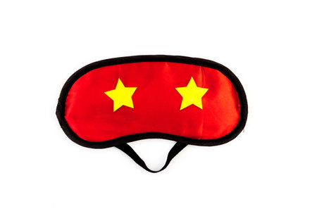 Red sleep mask on a white background. The concept of healthy sound sleep.の写真素材