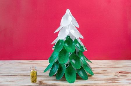 Christmas tree made of disposable spoons. step by step instruction. Handmade, DIY. Plastic recycling concept.の写真素材
