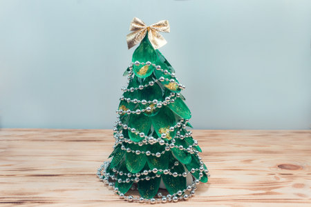 Christmas tree made of disposable spoons. step by step instructions. Handmade, DIY. Plastic recycling concept. The final result.の写真素材