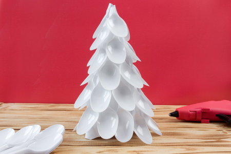 Christmas tree made of disposable spoons. step by step instruction. Handmade, DIY. Plastic recycling concept.の写真素材