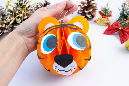 DIY colored paper tiger. Christmas and New Year's toy on the tree. Symbol of 2022. Children's crafts. step by step instruction. final result.の写真素材