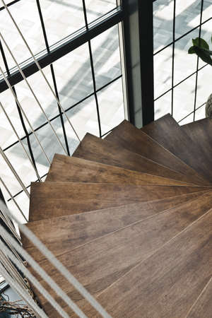 Stylish wooden spiral staircase, modern style.
