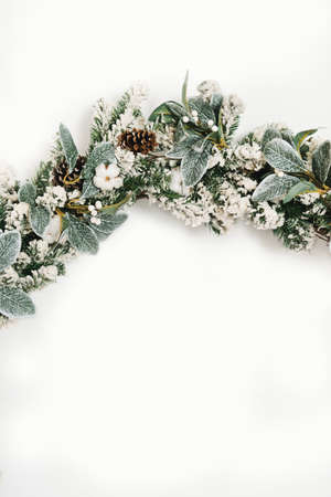 Christmas wreath on a white background. Background, space for text. Christmas composition. Wreath made of christmas tree branches.の写真素材