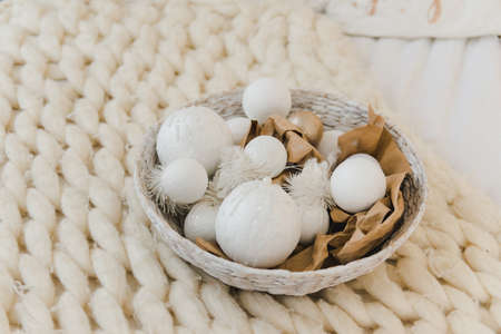 Wicker basket with white Christmas tree toys and balls. Christmas composition.