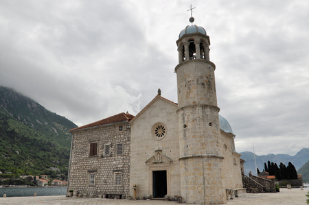 Arrival to the famous Our lady of the reef Island and Church in Kotor Bay of Montenegroの写真素材