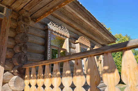 Closeup of window with carved wooden frame, decorated in traditional Russian style.の写真素材