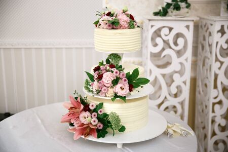 original wedding cake decorated with fresh flowersの写真素材