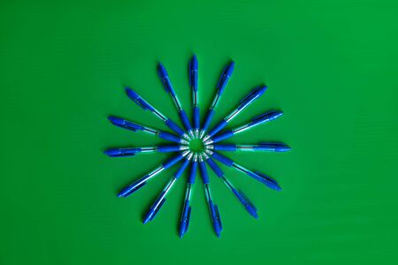 blue ballpoint pens on a green backgroundの写真素材