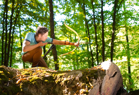 Young archer training in the sun rays.の写真素材