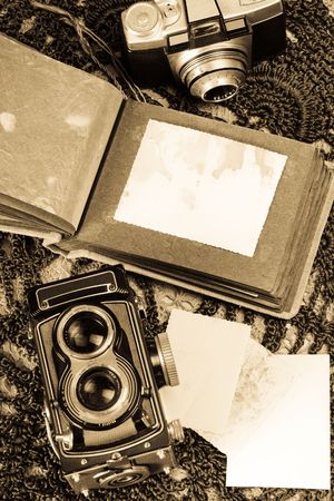 Old photo album and two film cameras.