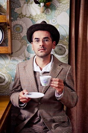 Retro man drinking coffee or teaの写真素材