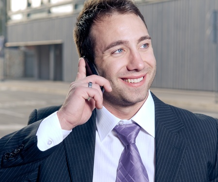Happy businessman speaking on the mobile phone