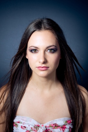 Beautiful caucasian brunette girl on dark background の写真素材