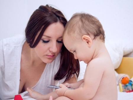 Mother and little boy using smartphoneの写真素材