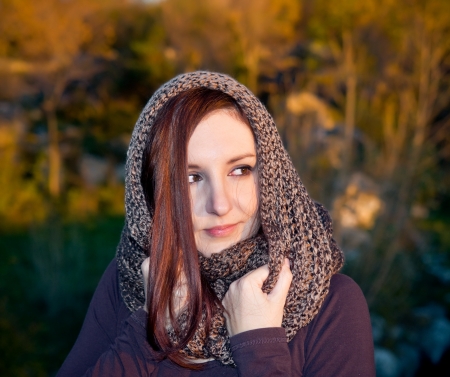 Autumn woman portrait with nature on the background