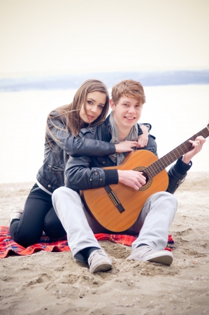Teen couple on the beach の写真素材