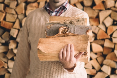 Man holding pile of chopped woodの写真素材