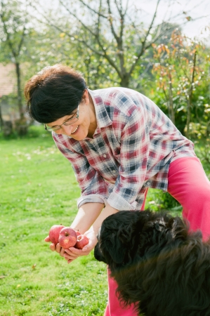 Real woman holding organic applesの写真素材