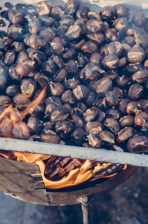 Tasty roasted chestnuts at open fireの写真素材