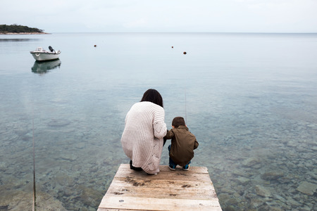 Mother and her son looking for a fishの写真素材