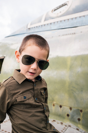 Little boy with sunglasses sitting on the airplaneの写真素材