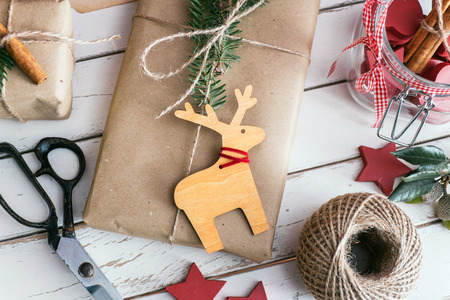 Homemade wrapped christmas presents with tools and decorationsの写真素材