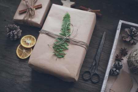 Homemade wrapped christmas presents with tools and decorationsの写真素材