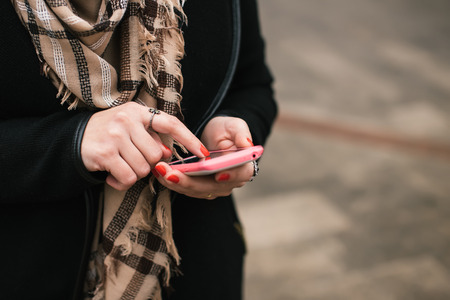 Close-up Of Woman's Hand Using Cell Phoneの写真素材