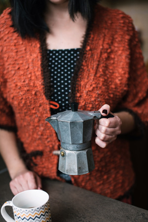 Woman holding old italian coffee makerの写真素材