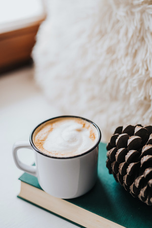 Delicious coffee in metal cup and a bookの写真素材