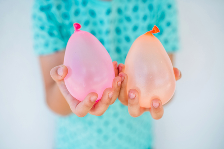 Boy is holding water balloonsの写真素材