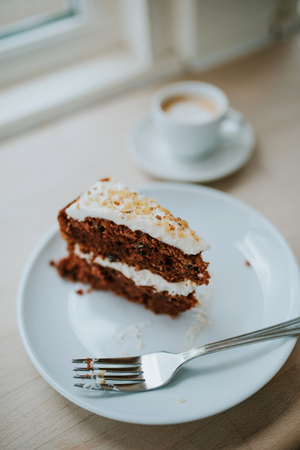 Carrot cake and coffee in cafeの写真素材