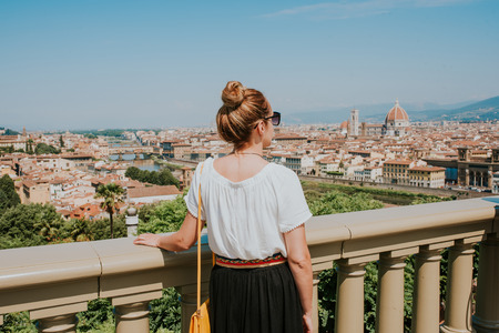Woman looking at the city of Florenceの写真素材