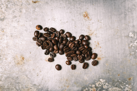 Roasted coffee bean on vintage metal surfaceの写真素材