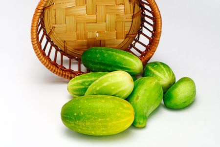 cucumbers and wooden  basket isolatedの写真素材