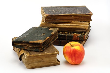 old  religious books and apple on whiteの写真素材