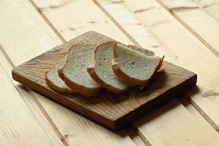 slice bread on wooden plateの写真素材