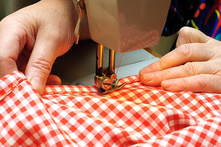  Hands stitching denim cloth with a sewing machineの写真素材