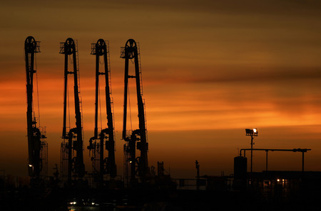 Silhouette. Part of Cargo Vessel oil crane with the yellow sky in the middle of the Straits of Malacca in the waters of Port Dickson Beach, Malaysia on November 20, 2017.のeditorial素材