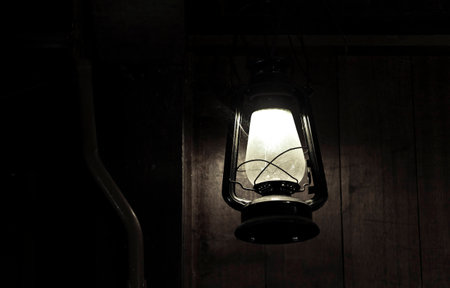 Traditional light lamp with black wooden backgroundの写真素材