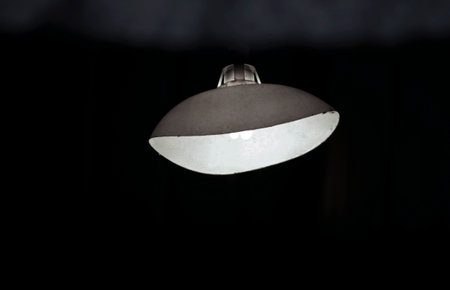 Plastic cover curved in the middle of a light with dark background