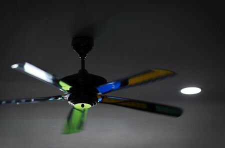 Motion blur. Blurred. Black fan on the ceilingの写真素材