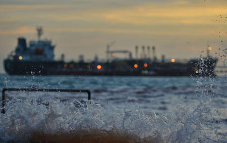 Splashes of water on the beach against the backdrop of  sunsetの写真素材