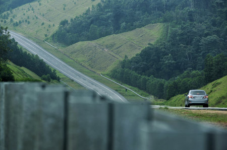 Cars through hilly roads at the morningの写真素材