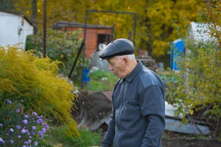 the elderly man in a cap against the natureの写真素材