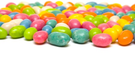 Set of sweet dragees of different color on white background