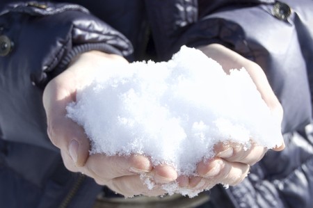 Snow is in masculine hands. Closeup, outdoorの写真素材